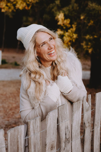 A woman is wearing alpaca accessories and an alpaca coat.