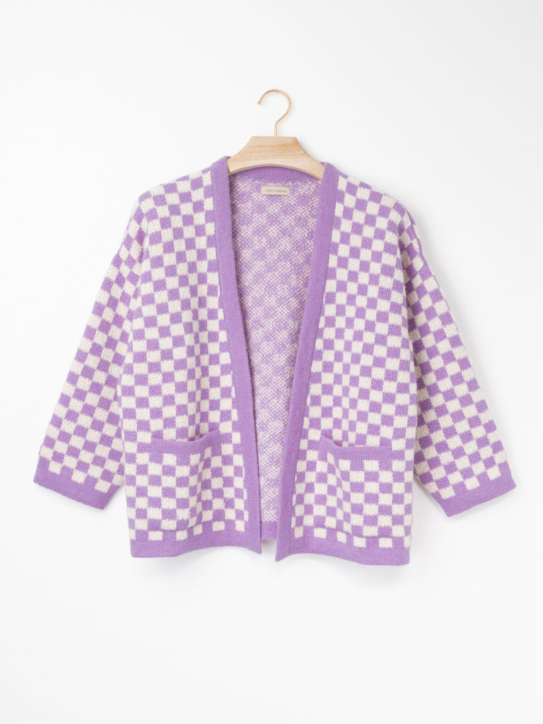 Checkerboard Alpaca Cardigan in a relaxed boxy fit, crafted from a soft alpaca blend with a black and natural checkerboard pattern, open front and front patch pockets.