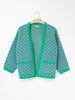 Checkerboard Alpaca Cardigan in a relaxed boxy fit, crafted from a soft alpaca blend with a black and natural checkerboard pattern, open front and front patch pockets.